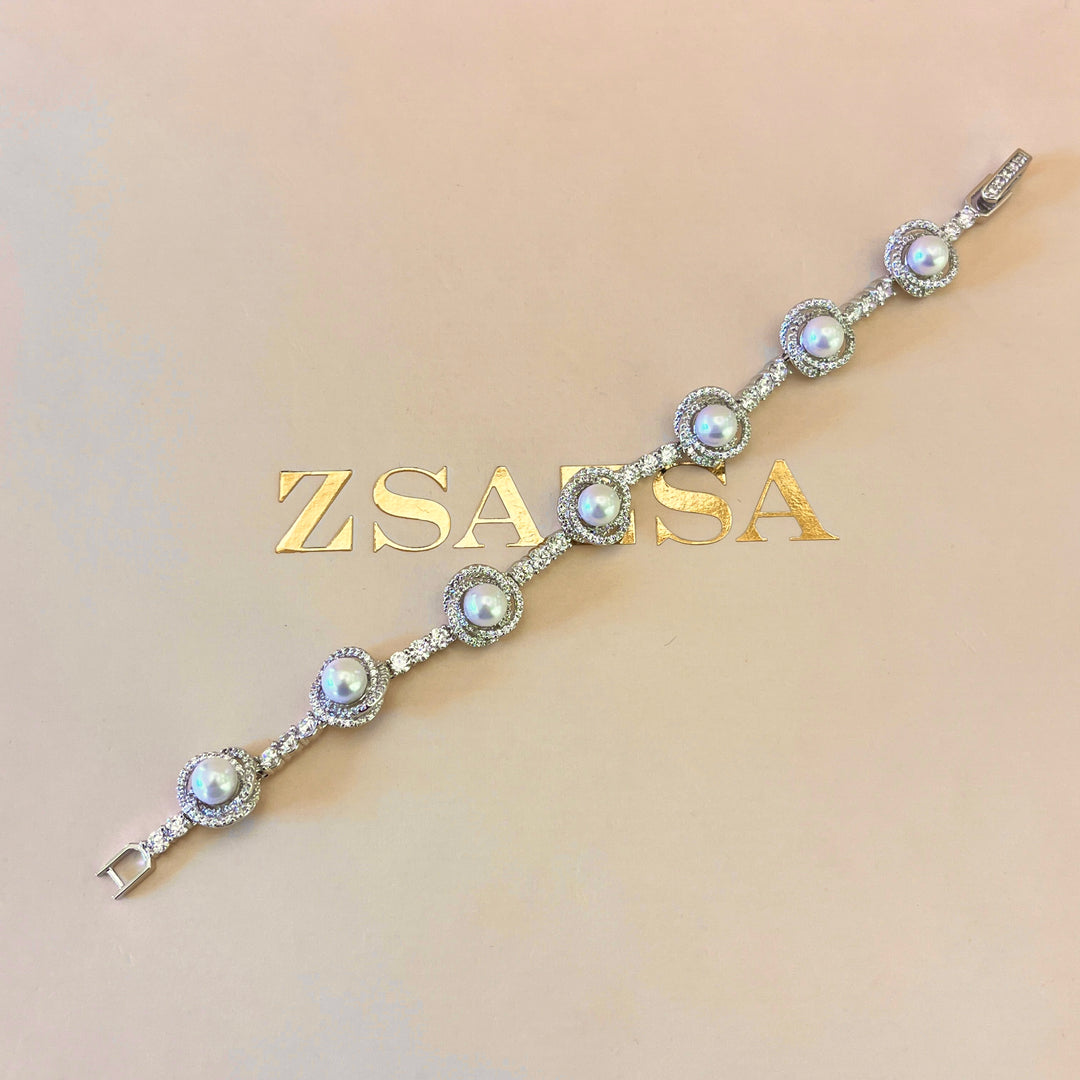 Zircone and white pearls white gold plated crossed set