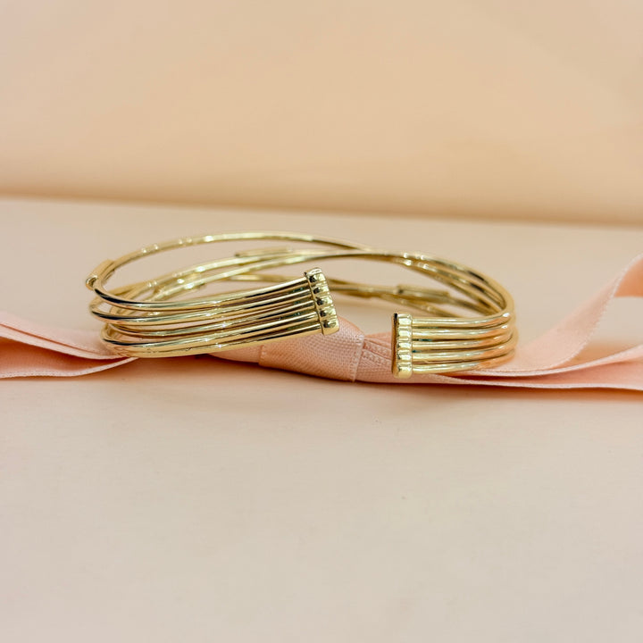 Zircone crossed gold plated sterling silver bangle