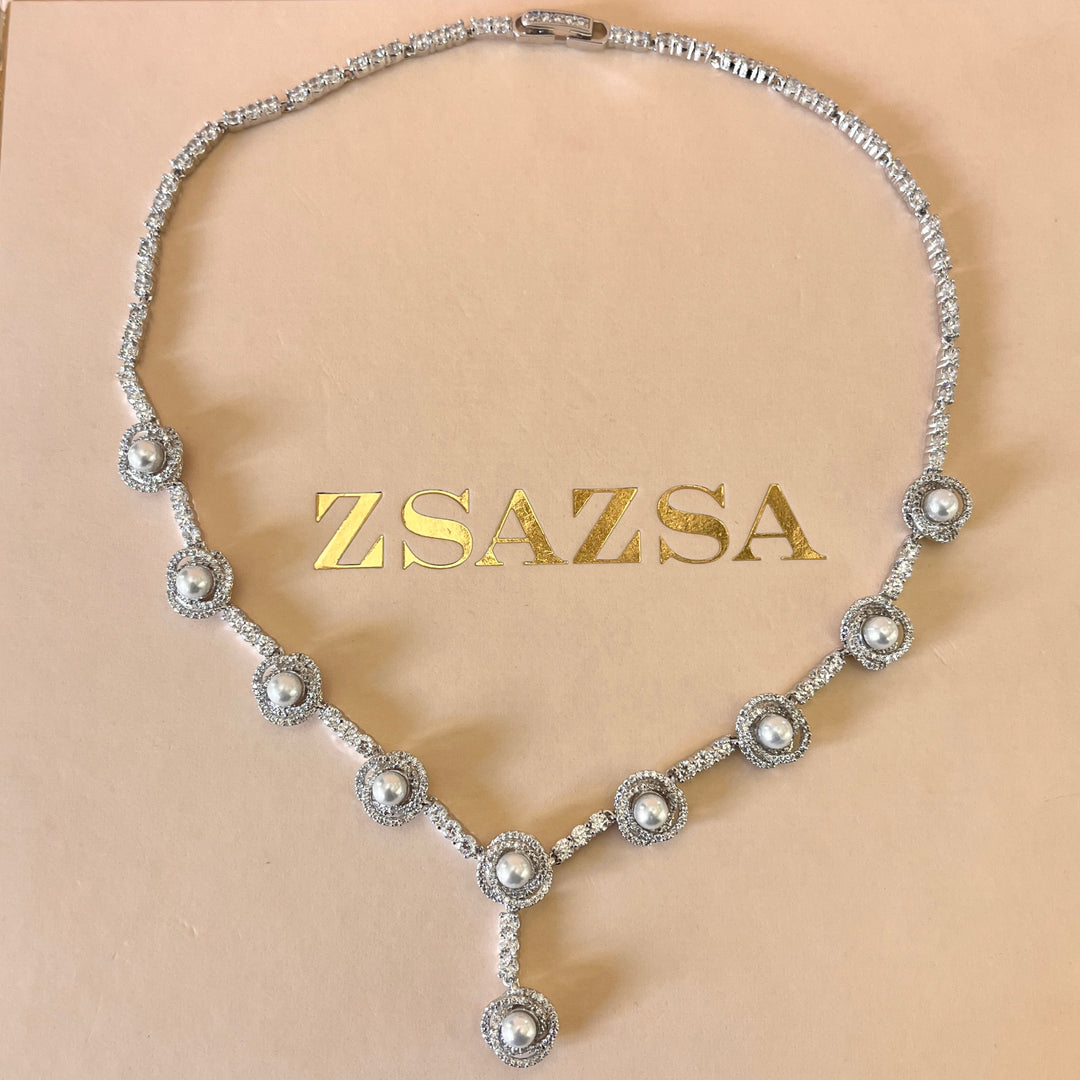 Zircone and white pearls white gold plated crossed set