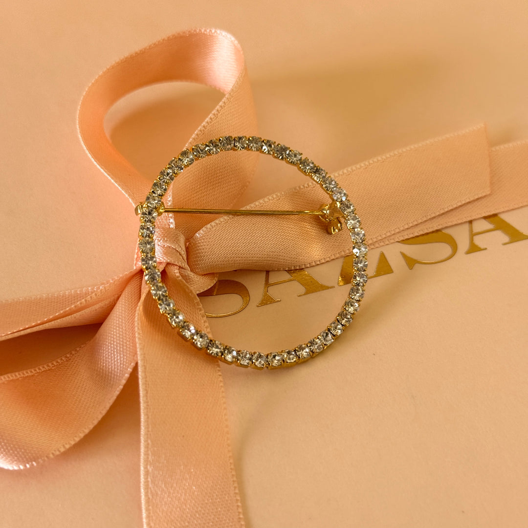 Round rhinestone gold plated brooch