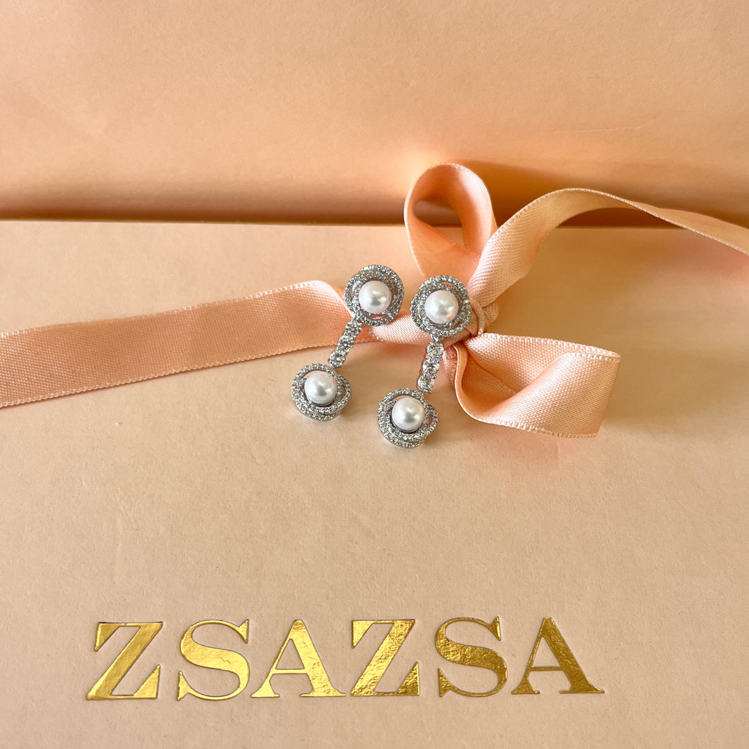 Zircone and white pearls white gold plated crossed set