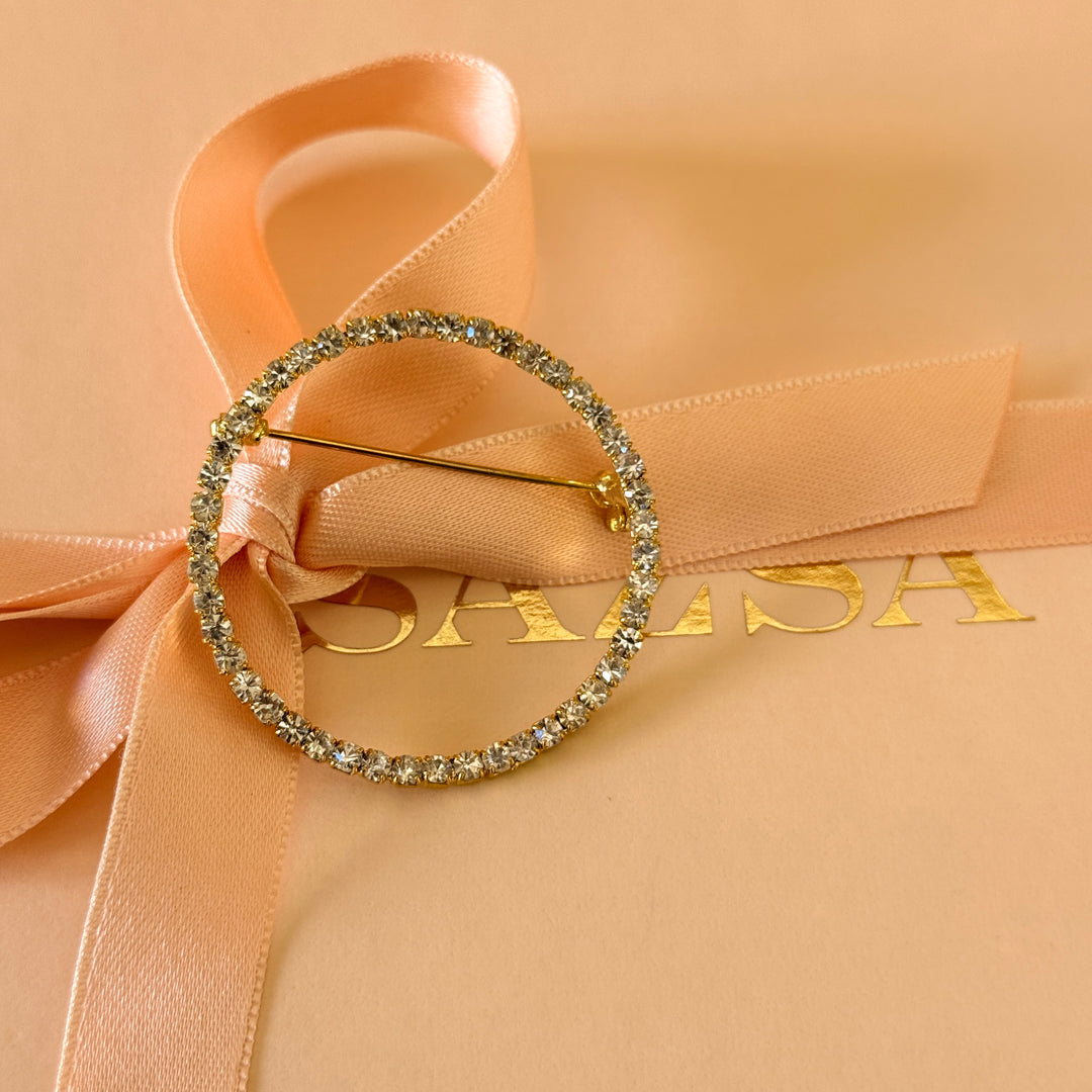 Round rhinestone gold plated brooch