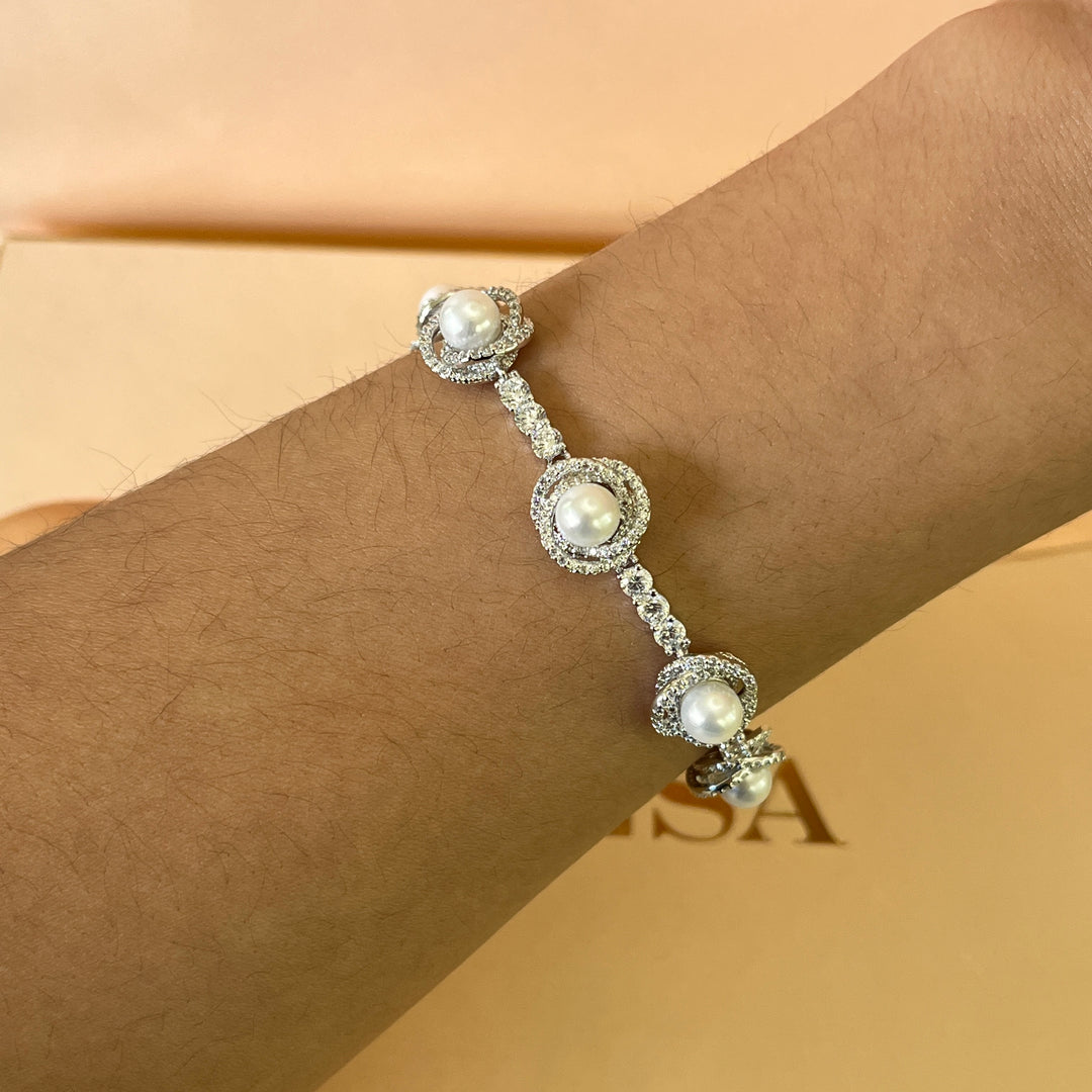 Zircone and white pearls white gold plated crossed set