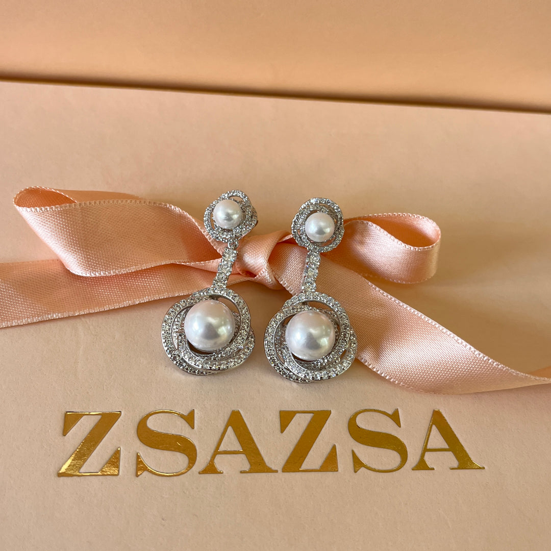 Zircone and white pearls white gold plated crossed set