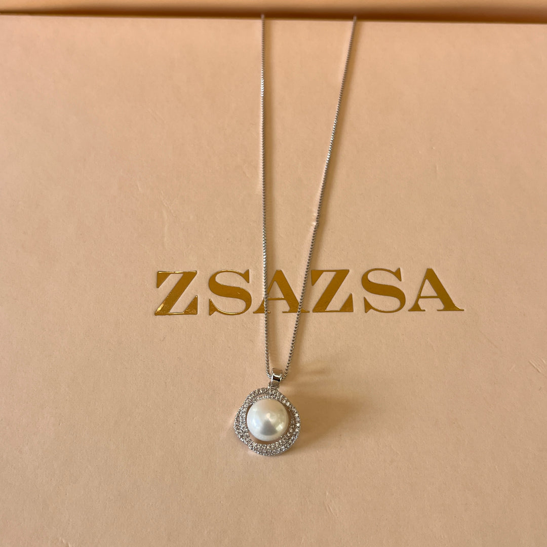 Zircone and white pearls white gold plated crossed set