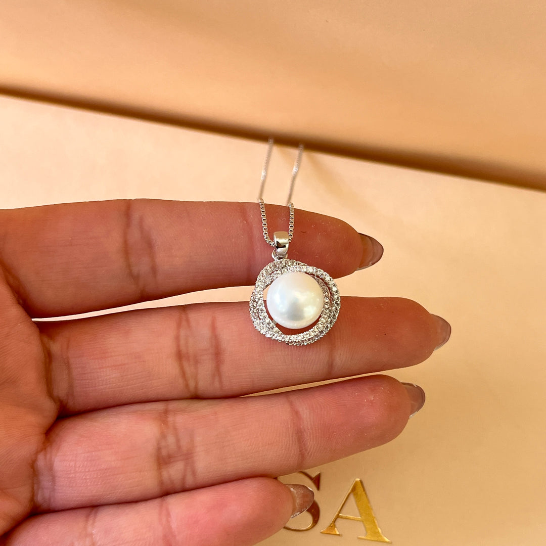 Zircone and white pearls white gold plated crossed set