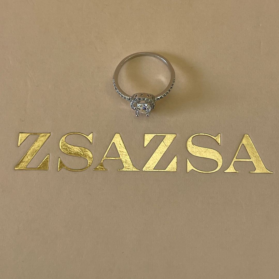Zircone solitaire with small crystals ring in white gold plating