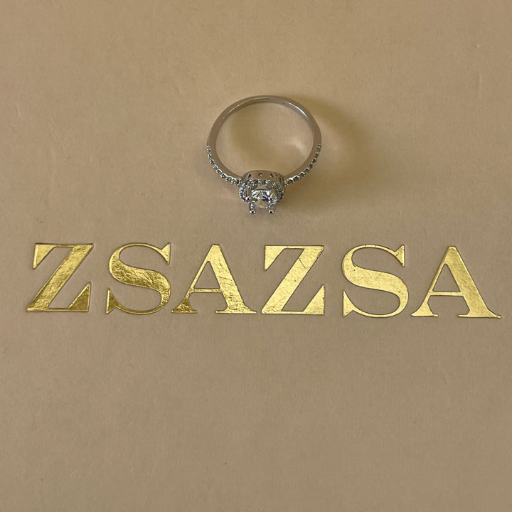 Zircone solitaire with small crystals ring in white gold plating