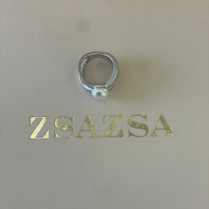 Silver crossed design with a dainty pearl ring in white gold plating