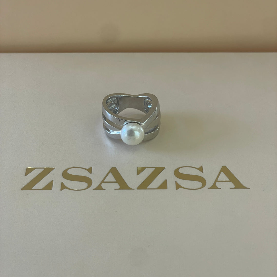 Silver crossed design with a dainty pearl ring in white gold plating